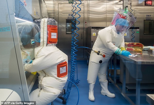 Workers are seen next to a cage with mice inside the P4 laboratory in Wuhan. It has been revealed that the lab also carried out research on bats from the source location of COVID-19